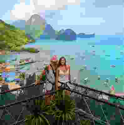 Two women travellers smiling on the canopy walk over El Nido.