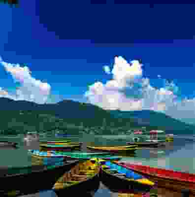 Long boats docked in the lake of Pokhara.