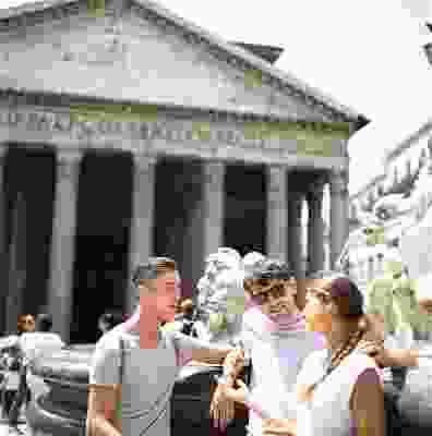 Three travellers talking whilst stood in front of the Rome Pantheon.