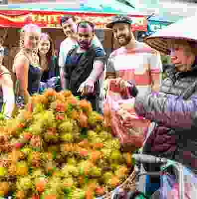 Travellers exploring the produce from the local markets in Hanoi.