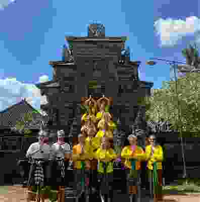 Travellers wearing traditional clothing whilst posing in front of Canggu temple.