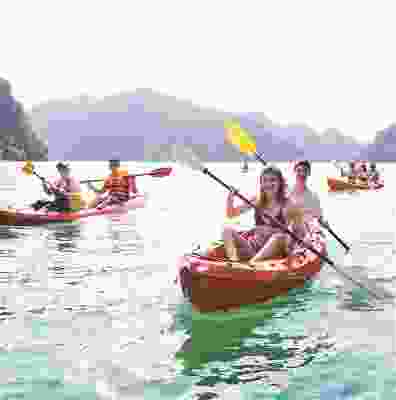 Travellers kayaking down the ocean of Ha long bay.