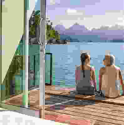 Two travellers enjoying the view from a floating bungalow.