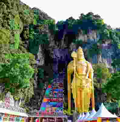 The view of gold statue outside of the Batu caves.