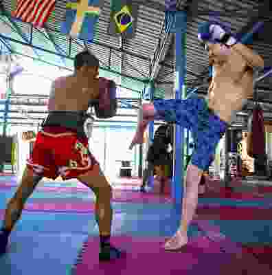 Two men taking part in Muay Thai boxing.