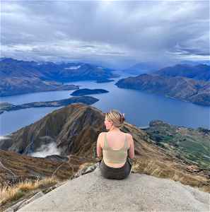 Traveller looking across from Roys Peak in New Zealand 