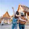 Two travellers looking over Thailand temple 